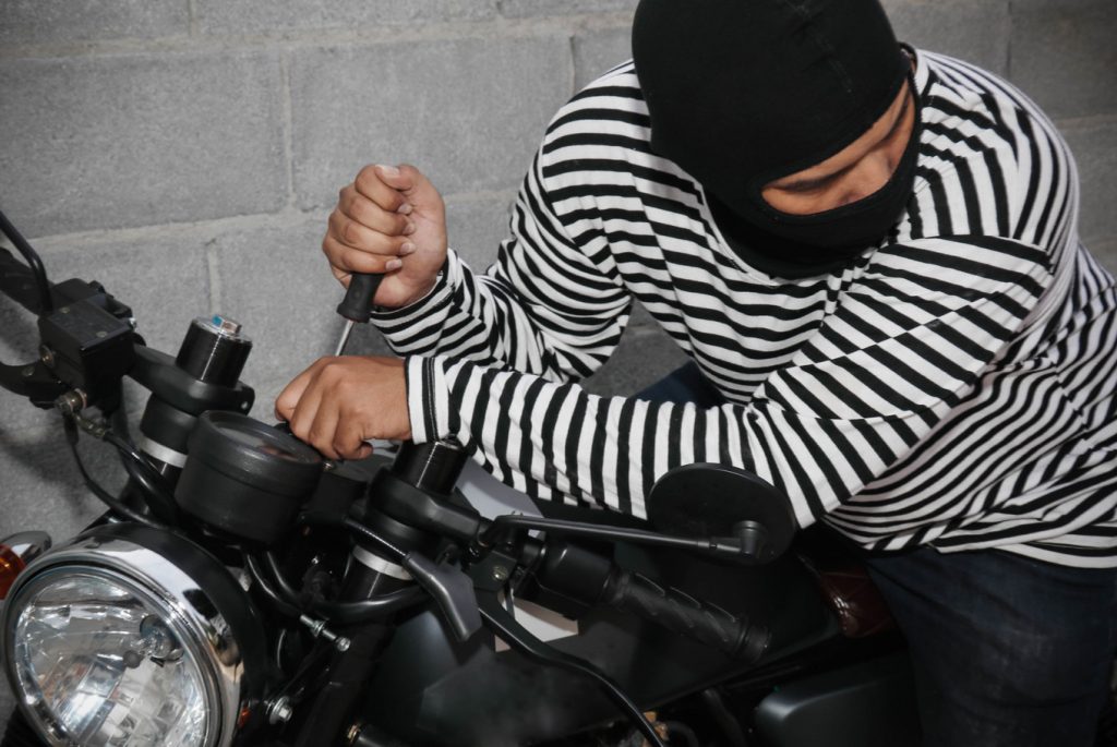 Example of a motorcycle being stolen. (Shutterstock.com/chalermphon_tiam)